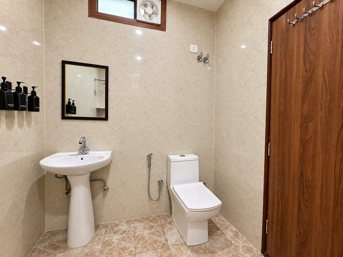 A bathroom at Mulberry Farm with basin, mirror and WC