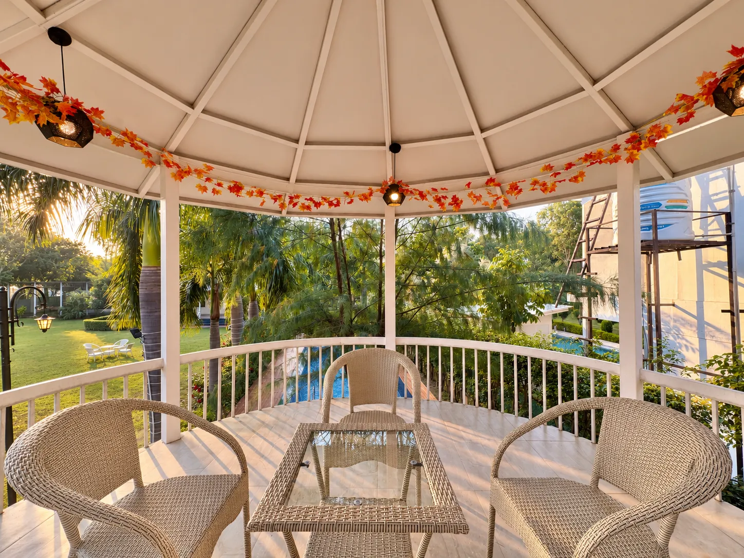The upper deck of the machan at Mulberry Farm, looking out over the lawn at dusk